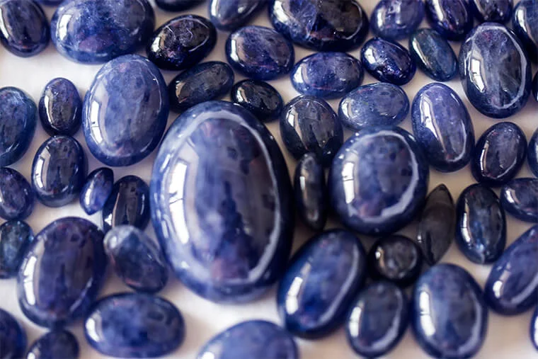 Polished blue gemstone cabochons graded by size