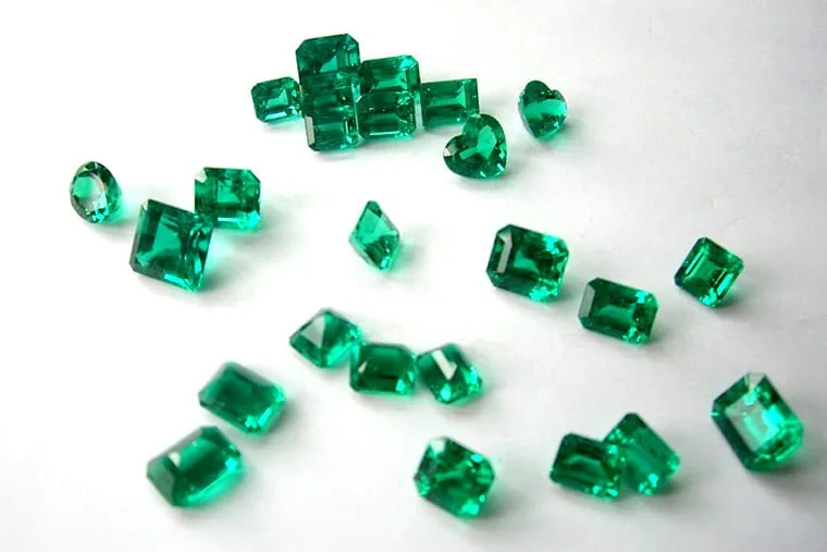 Parcel of emerald-cut green gemstones sorted for a production run